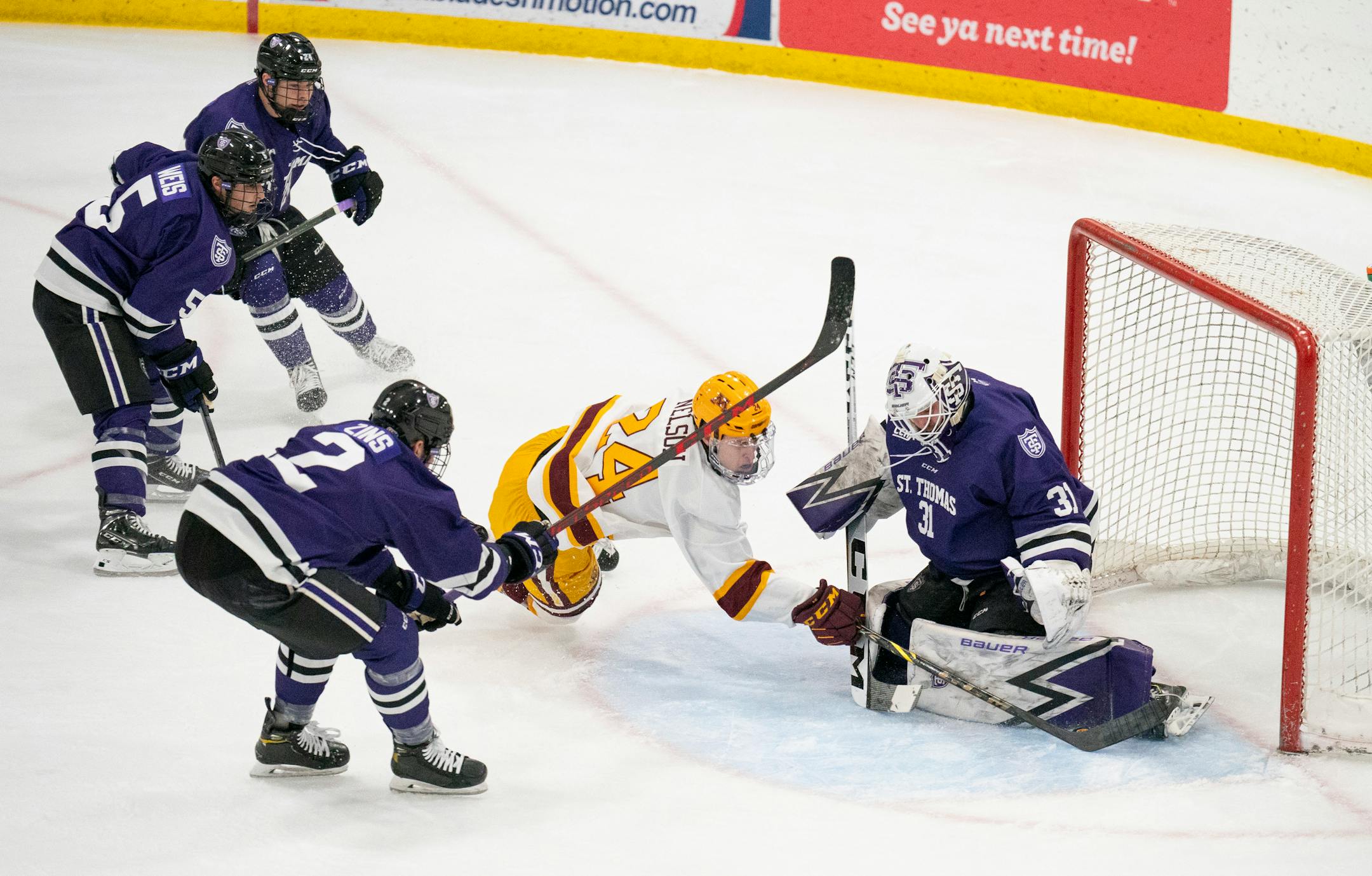 Tommies goaltender Jacob Berger (31) stopped a first period shot by Gophers forward Jaxon Nelson (24) Sunday afternoon, Jan. 2, 2022 at Doug Woog Arena in South St. Paul.