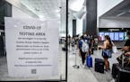 Passengers arriving from four Mediterranean countries at Milan's Malpensa airport wait in a line to be tested for COVID-19, Thursday, Aug. 20, 2020. I
