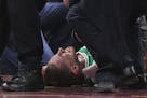 Boston Celtics forward Gordon Hayward lays out the ground while medics check his injury after a play against the Cleveland Cavaliers in the first quar