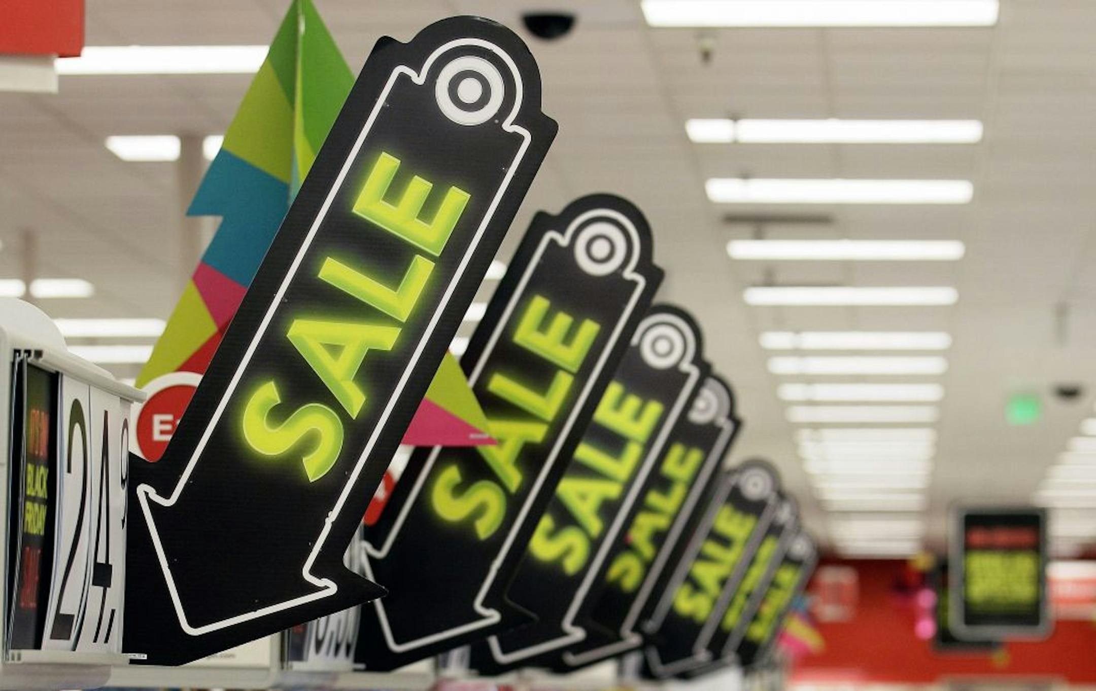 FILE -In this Friday, Nov. 23, 2012, file photo, sale signs are displayed at a Target store in Colma, Calif. Big retailers, from Best Buy to Target to Toys R Us, are engaging in a price war this holiday season, and shoppers can score some good deals if they know how to navigate them. But what's different this holiday season is that Best Buy and Target are matching online retailers such as Amazon.com for the first time. That's a big deal, since online prices tend to be lower than those in the sto