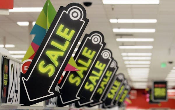 FILE -In this Friday, Nov. 23, 2012, file photo, sale signs are displayed at a Target store in Colma, Calif. Big retailers, from Best Buy to Target to