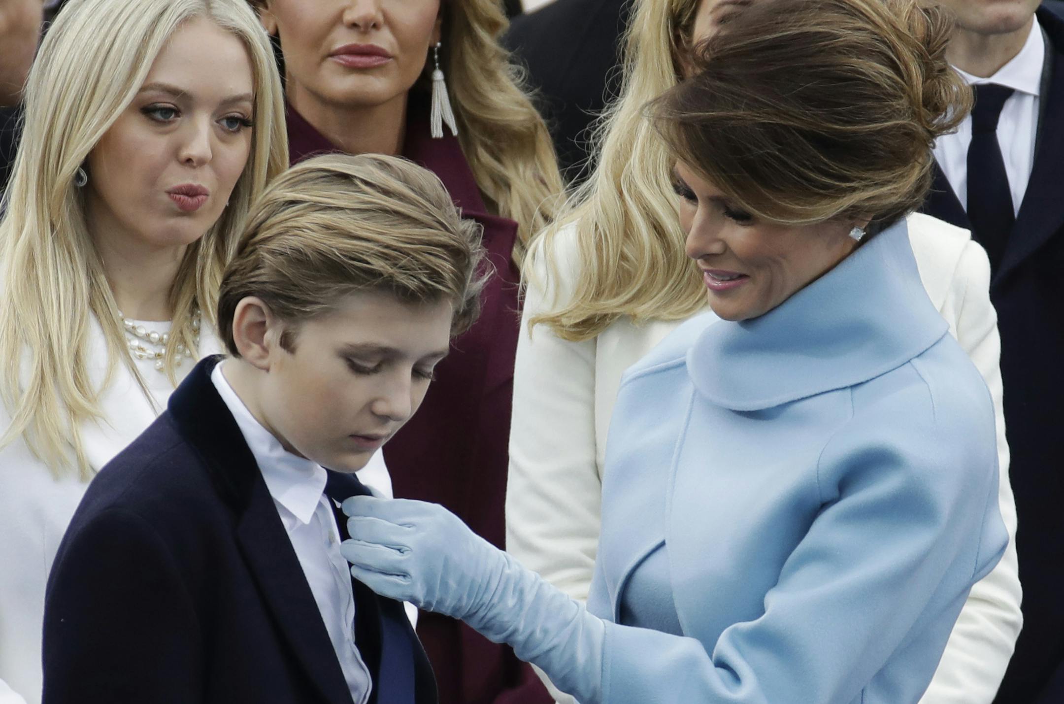 President-elect Donald Trump's wife Melania Trump adjusts Barron Trump's tie before the 58th Presidential Inauguration for President-elect Donald Trump at the U.S. Capitol in Washington, Friday, Jan. 20, 2017. (AP Photo/Patrick Semansky)