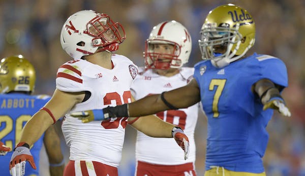 Nebraska linebacker Aaron Gabriel, left, and kicker Brett Maher react after they missed a field goal as UCLA safety Tevin McDonald gestures during the