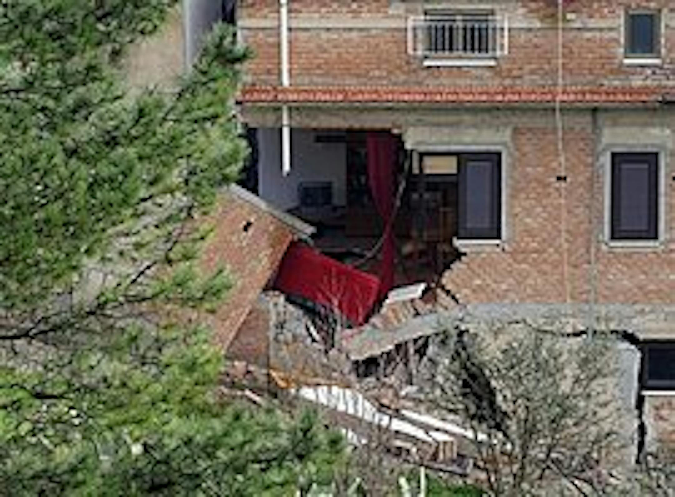 A view of a damaged house a day after a landslide in San Fratello near Messina, southern Italy, early Monday, Feb. 15, 2010. Some 1500 people were evacuated Monday after a landslide on Sunday destroyed a part of San Fratello village, near Messina. (AP Photo/Carmelo Imbesi)