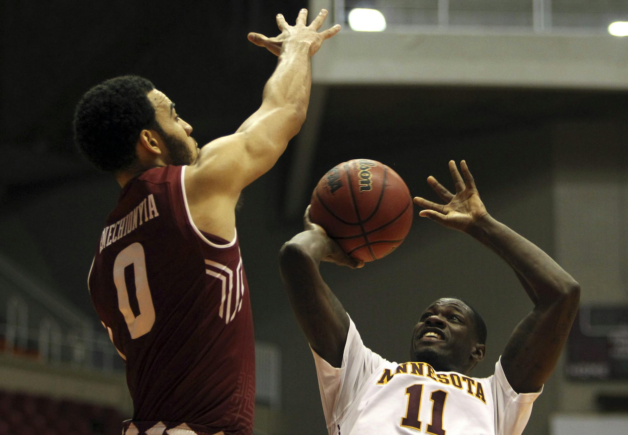 Minnesota guard Carlos Morris, right, goes to the basket against Temple forward Obi Enechionyia, during the college basketball tournament, Puerto Rico Tip-Off, in San Juan, Thursday, Nov. 19, 2015. (AP Photo/Ricardo Arduengo)