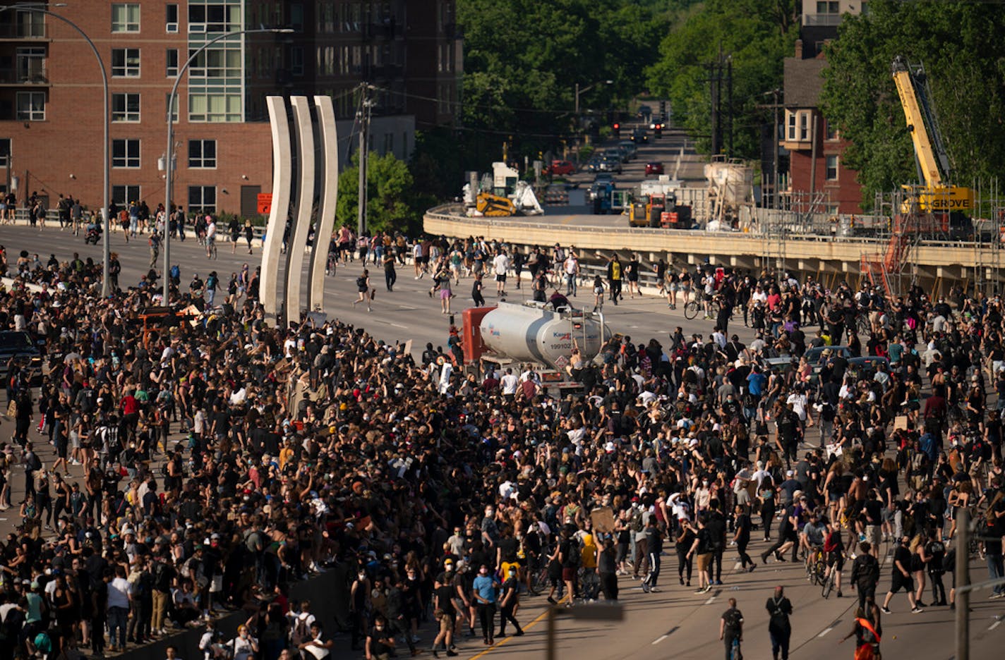 People climbed atop a tanker truck driven by Bogdan Vechirko as it continued to move after driving through protesters who had shut down the Interstate 35W bridge May 31.