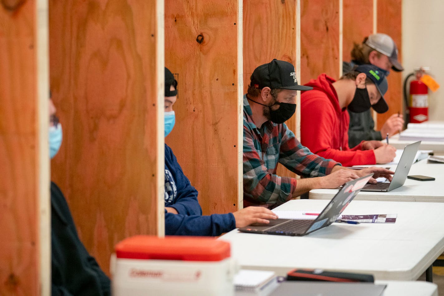 Students in a Commercial and Residential Wiring class at Lake Superior College have their own wooden cubicles to help promote better social distancing.