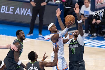 The Thunder's Shai Gilgeous-Alexander is defended by the Timberwolves' Naz Reid (11) in the first quarter of Game 1 of the Western Conference finals a