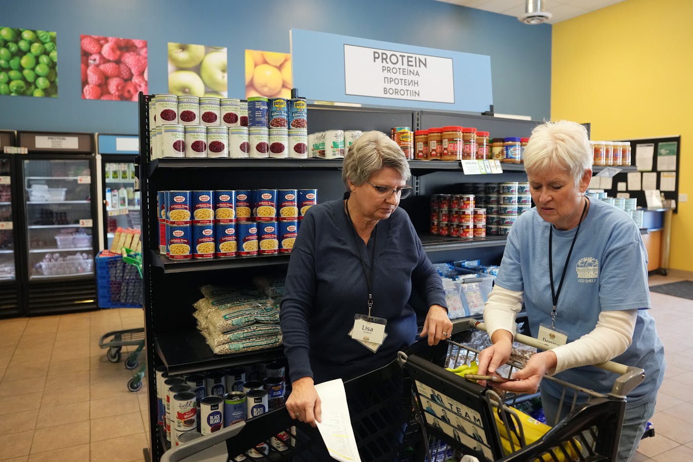 Volunteers Lisa Polzin, left, and Denise Nelson help pack more than 40 boxes of groceries to be delivered to area families in need of food assistance Tuesday, Jan. 16, 2024 at Bountiful Basket Food Shelf in Chaska, Minn.    ] ANTHONY SOUFFLE • anthony.souffle@startribune.com