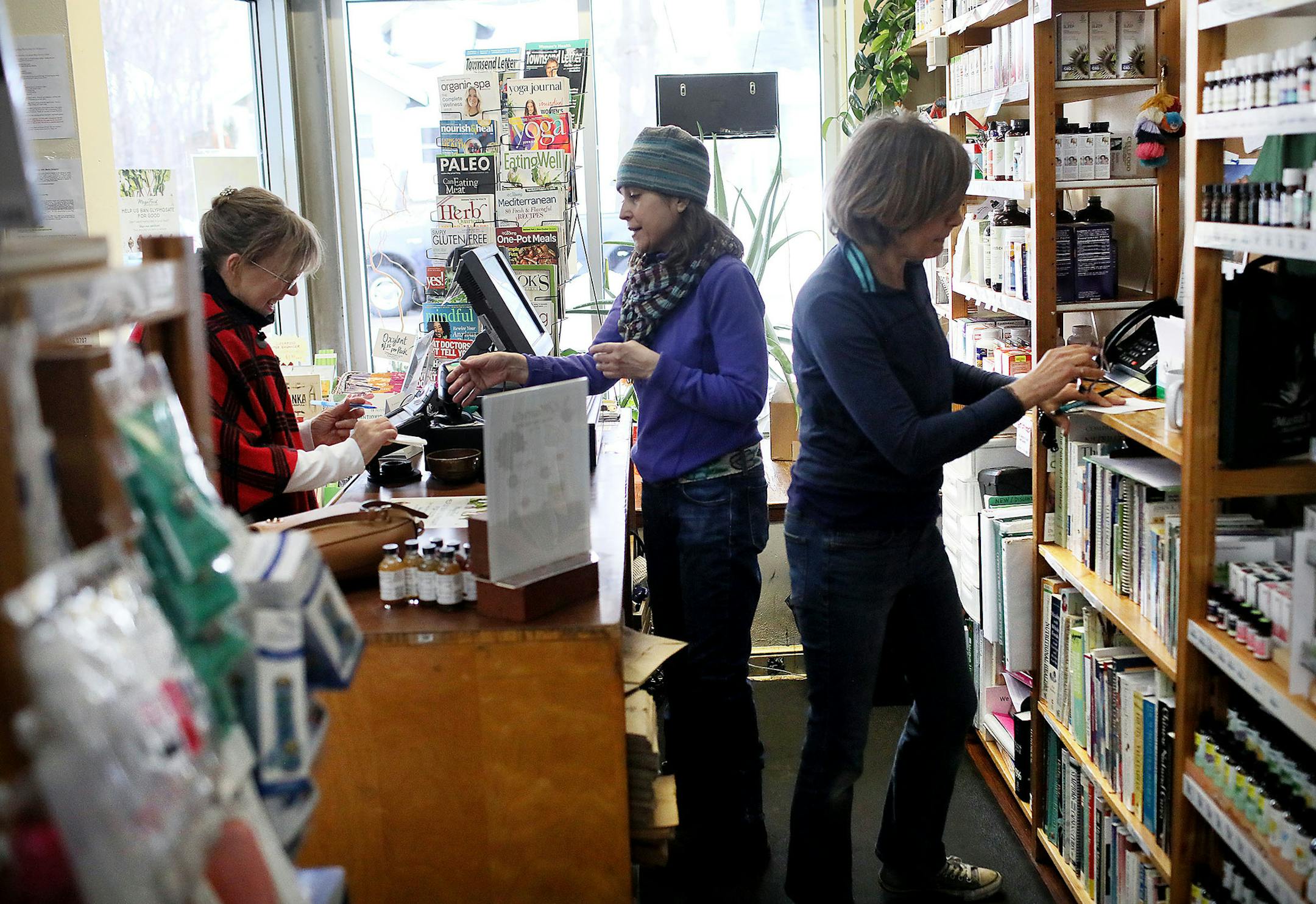 Mastel's Health Foods is a quirky little store in St. Paul that claims to be the oldest health and wellness store in the state. Here, Sue Bryant, middle, a sales associate at Mastel's, checks out customer Debby Newman of Roseville, left, while Mastel's sales associate Roberta Benson, answers the phone Tuesday, March 12, 2019, in St. Paul, MN.] DAVID JOLES •david.joles@startribune.com A Mainstay feature about Mastel's Health Foods, a quirky little store in St. Paul that claims to be the ol