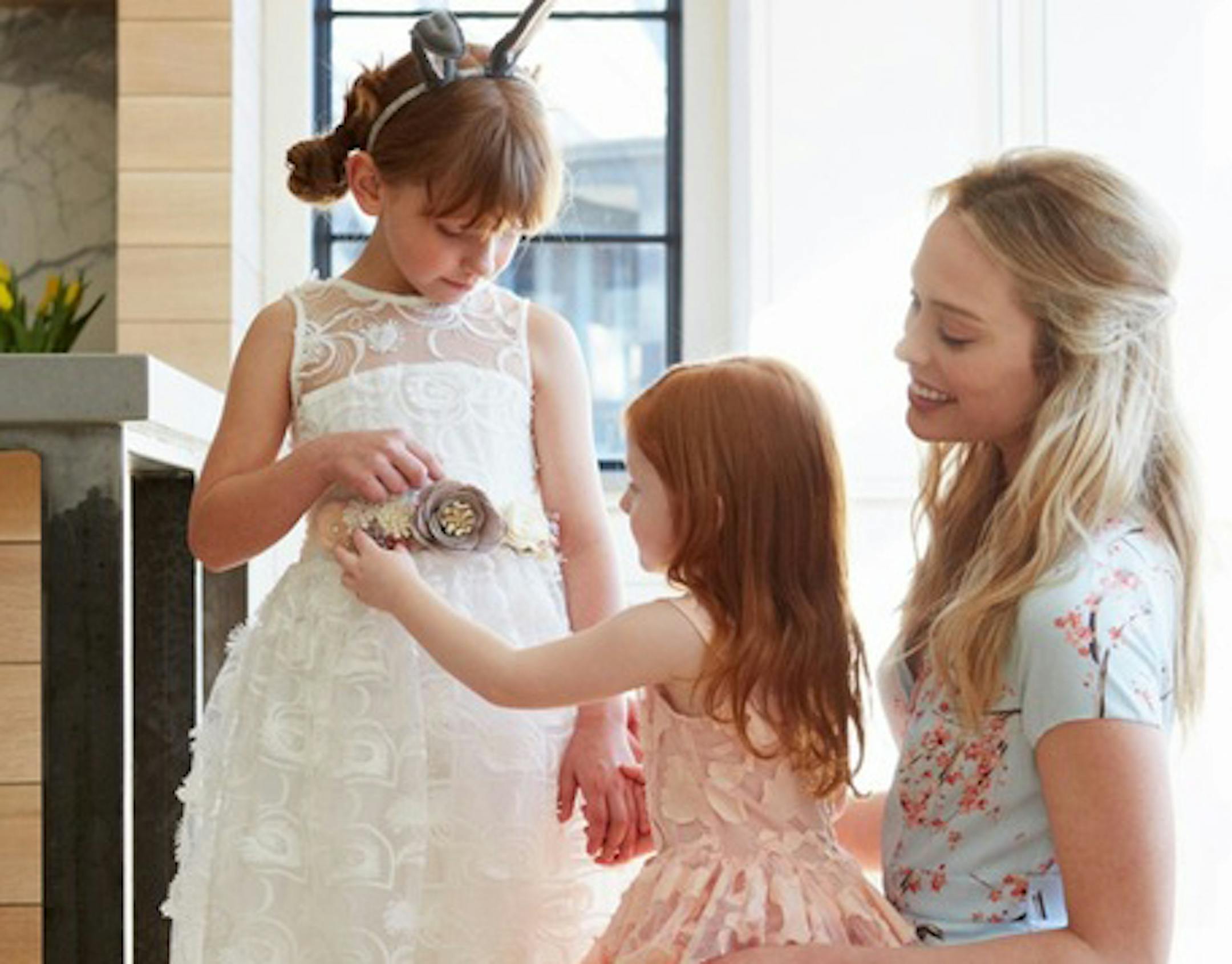 Amaya, left, wears bunny ears headband, $46, and felt flowers (as belt), $95, from Oh Baby!; Hepburn lace dress, $130, from Goodnight Moon, and Yeehaw perforated cowboy boots, $32, from Target. Bailey wears Pretty In dress, $98, from Goodnight Moon. Meridith wears Nordstrom Signature and Caroline Issa floral dress, $795, from Nordstrom.