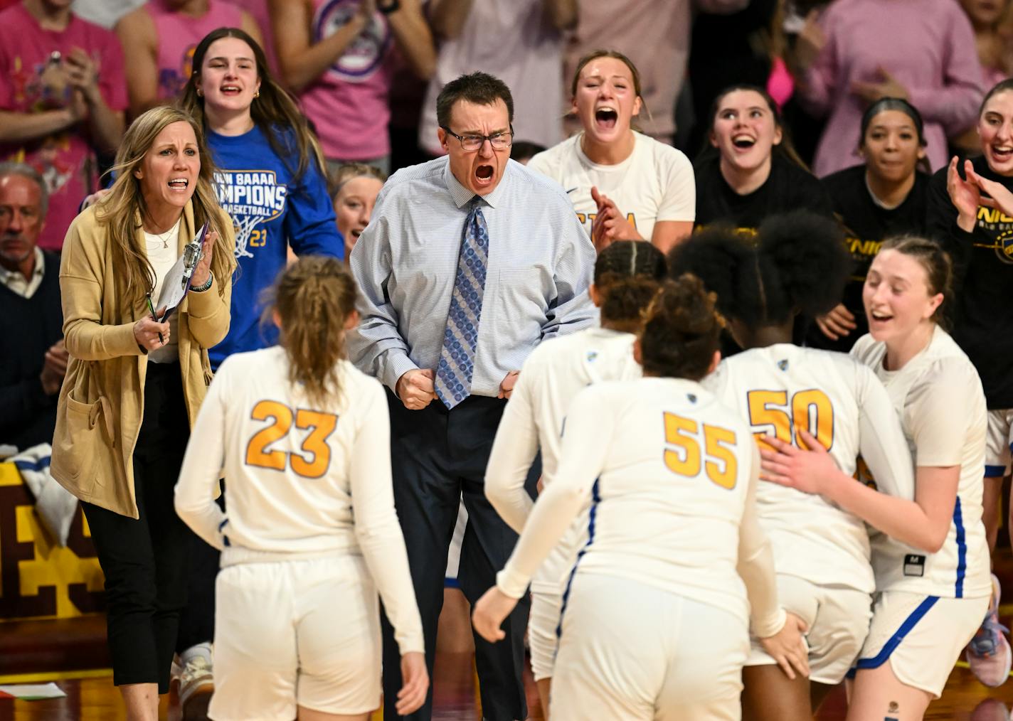 St. Michael-Albertville head coach Kent Hamre celebrates with players after a 3-pointer scored by guard JaKahla Craft (50) forces an Eden Prairie timeout in the first half Thursday, March 16, 2023 during the Class 4A girls' basketball state tournament semifinals at Williams Arena in Minneapolis, Minn.. ] AARON LAVINSKY • aaron.lavinsky@startribune.com