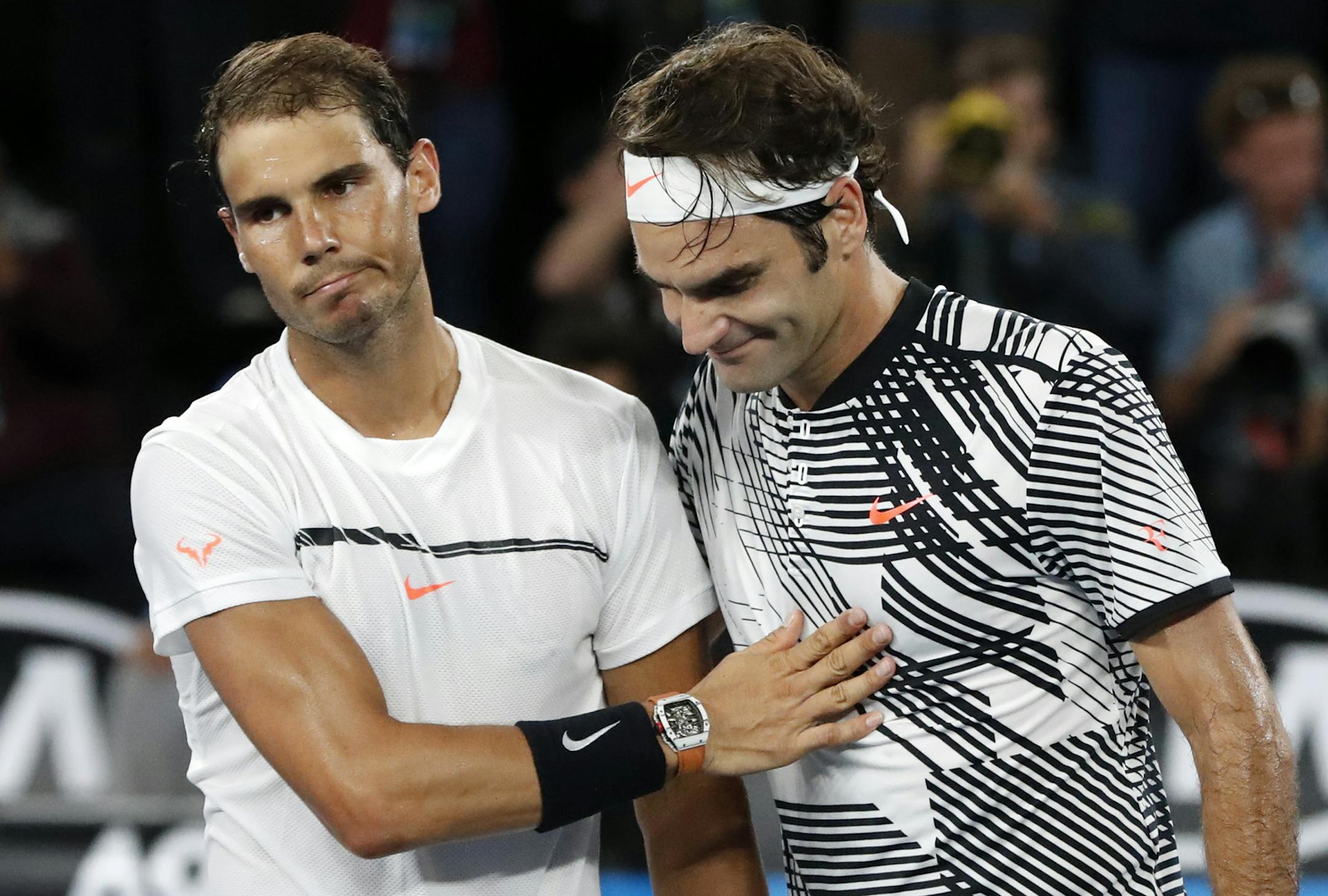Switzerland's Roger Federer, right, is congratulated by Spain's Rafael Nadal, after Federer won the men's singles final at the Australian Open tennis championships in Melbourne, Australia, Sunday, Jan. 29, 2017.(AP Photo/Dita Alangkara)