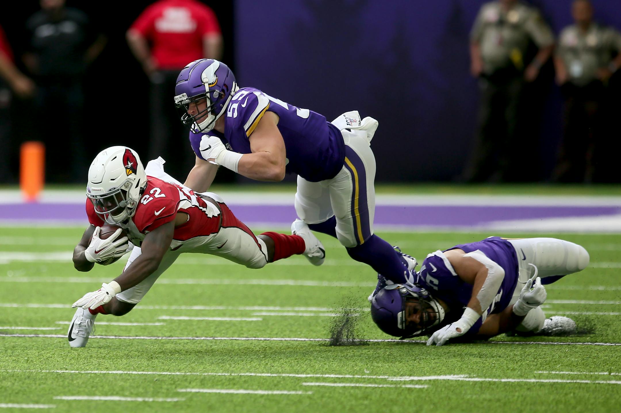 Arizona Cardinals running back T.J. Logan (22) runs from Minnesota Vikings linebacker Cameron Smith (59) during the second half of an NFL preseason football game, Saturday, Aug. 24, 2019, in Minneapolis. (AP Photo/Jim Mone)
