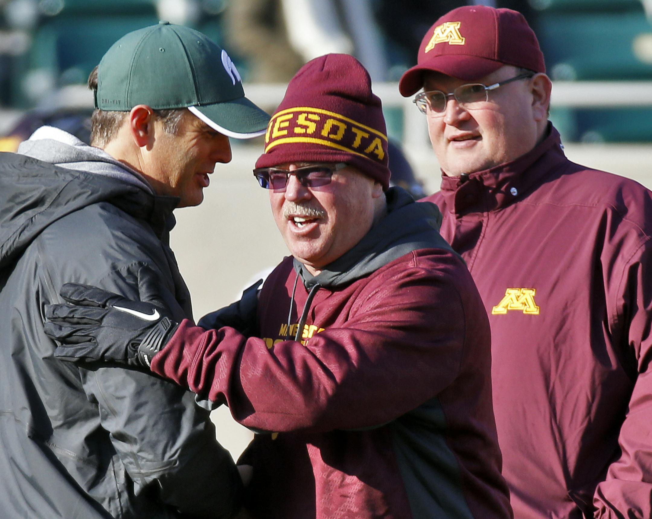 Jerry Kill, center, led the Gophers to a pair of 8-5 seasons, with the help of Tracy Claeys, right. Now it&#x2019;s Claeys&#x2019; show to run.