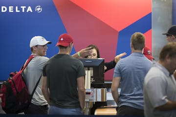 People waited at the check-in area for Delta Air Lines last year at the Minneapolis-St. Paul International Airport. If Delta paid $9,950 to each perso