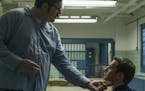 This image released by Netflix shows Cameron Britton, left, and Jonathan Groff in a scene from the 10-episode series, "Mindhunter," streaming on Netfl