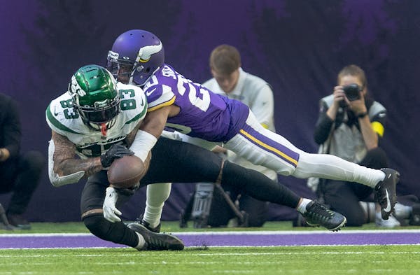 Duke Shelley (20) of the Minnesota Vikings breaks up a pass intended for Tyler Conklin (83) in the third quarter Sunday, December 4, 2022, at U.S. Ban