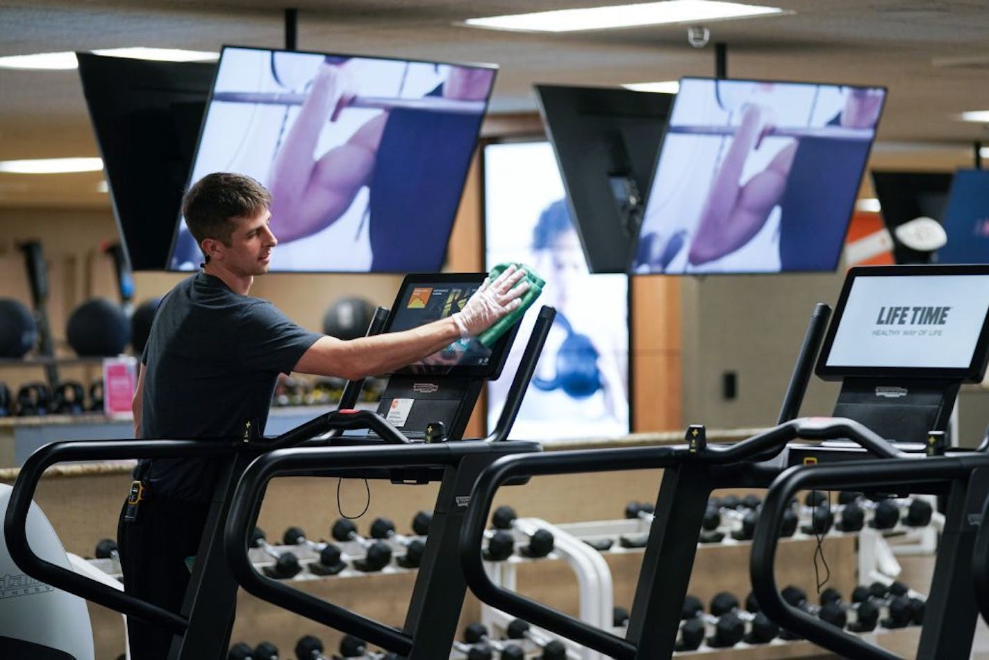 Bradley Carr cleaned exercise equipment at Life Time Fitness with Purell surface disinfectant more frequently on surfaces around the club.