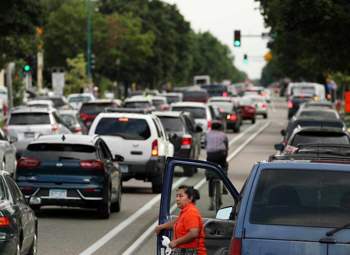 A woman watched as commuters navigated Portland Avenue southbound during the evening rush hour Friday. ] ANTHONY SOUFFLE &#x2022; anthony.souffle@startribune.com Commuters navigated Portland Avenue southbound during the evening rush hour Friday, June 15, 2018 in Minneapolis. The closed ramps on 35W are causing a lot more traffic to be routed through near south Minneapolis. Portland Avenue southbound is a parking lot at afternoon rush hour and impatient drivers dart down side streets to escape to