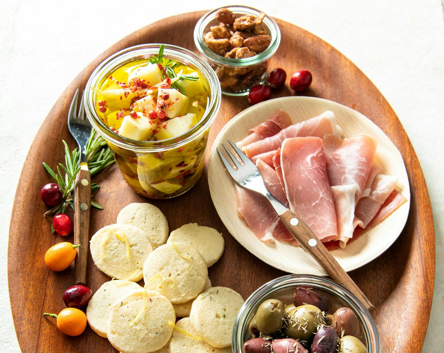 Homemade Rosemary-Lemon Shortbread, marinated cheese and spicy mixed nuts are supplemented with store-bought charcuterie for a festive appetizer board. Recipes by Beth Dooley, photo by Mette Nielsen, Special to the Star Tribune