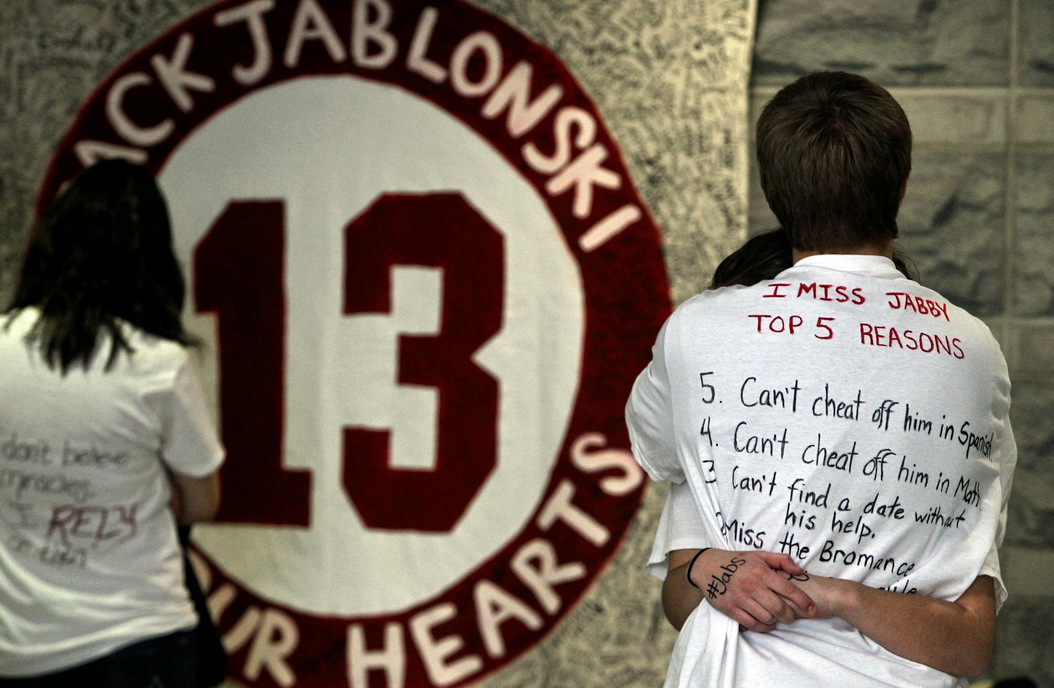Two Benilde-St. Margaret's students hugged in the hallway Thursday, Jan. 5, 2012, in St. Louis Park, Minn. On Thursday, students around the state wore white a message of support to Jack Jablonski.