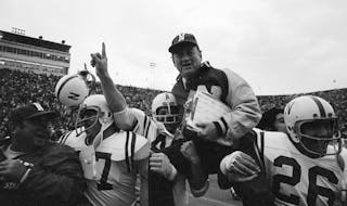 FILE - In this Nov. 25, 1971, file photo, Nebraska head coach Bob Devaney is carried off the field by his victorious players after they defeated Oklah