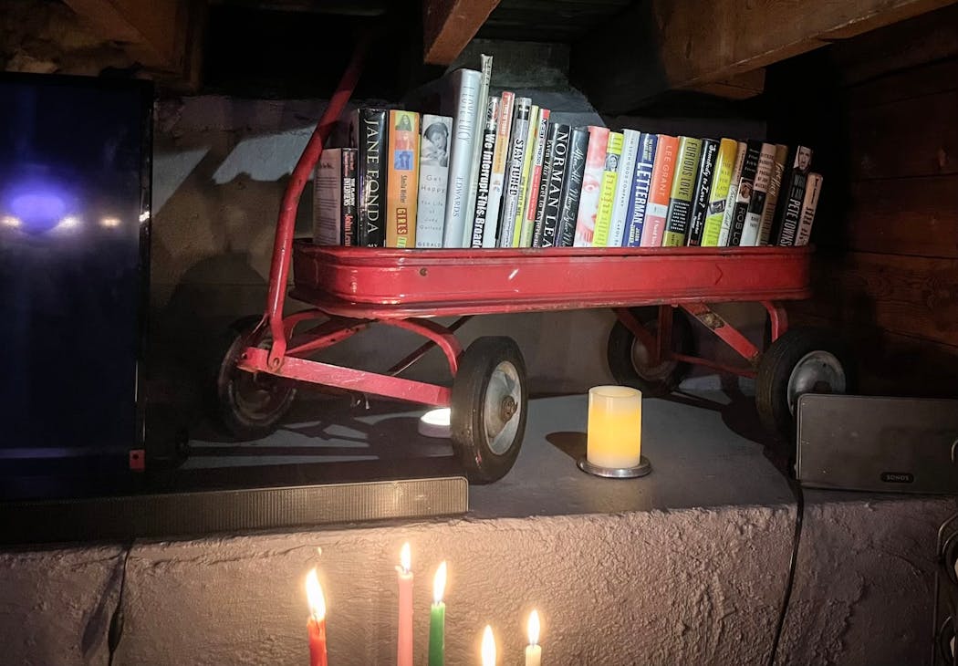 Tim Herbstrith finished the basement of his south Minneapolis home and created a 'speakeasy' decorated with repurposed family heirlooms. His grandma's wagon is recast as a bookstand. 