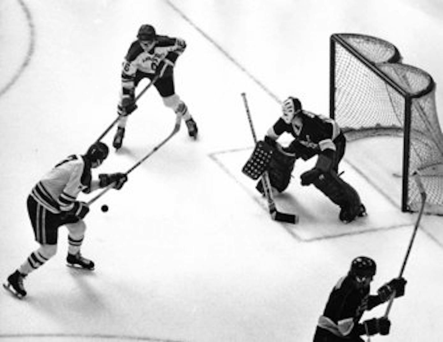 Hibbing High School's Joe Micheletti (7) bears down on International Falls goalie Peter (Pete) Waselovich in the semifinals of the Minnesota State High School Hockey Tournament Mar. 9, 1973. Hibbing won the game 5-4. Minneapolis Star staff photo by John Croft.