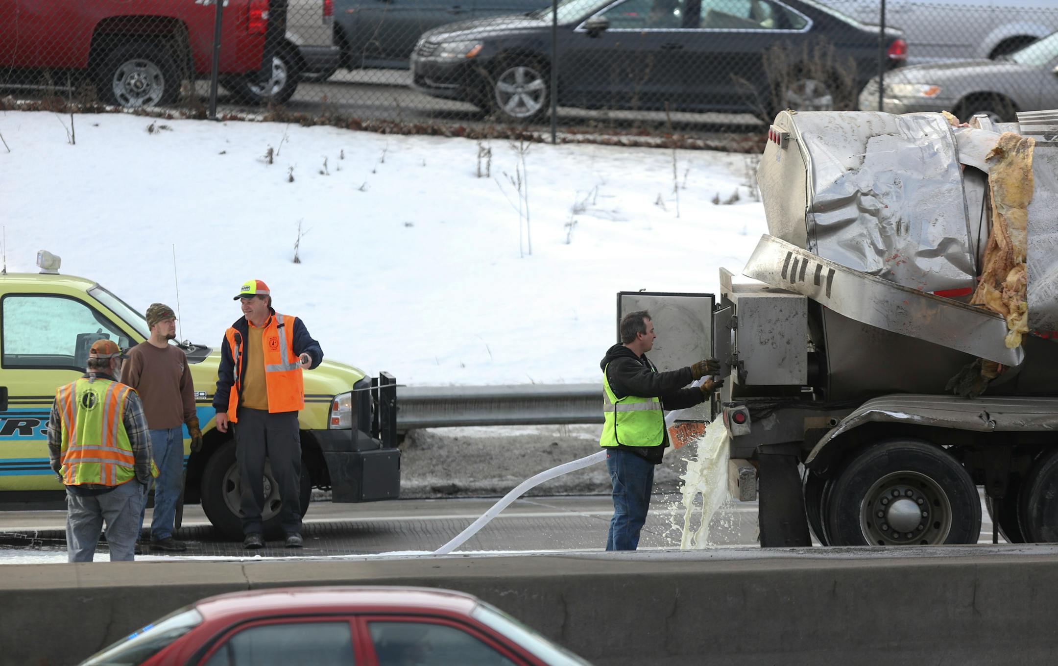 The milk truck involved in an accident was towed to the side of the road as the rest of the milk was drained out near the Lowry Tunnel in Minneapolis on Wednesday, February 27, 2013.