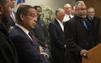 Keith Ellison, Minnesota Attorney General left, listens as John Harrington, Commissioner, Minnesota Department of Public Safety spoke about 28 recomme