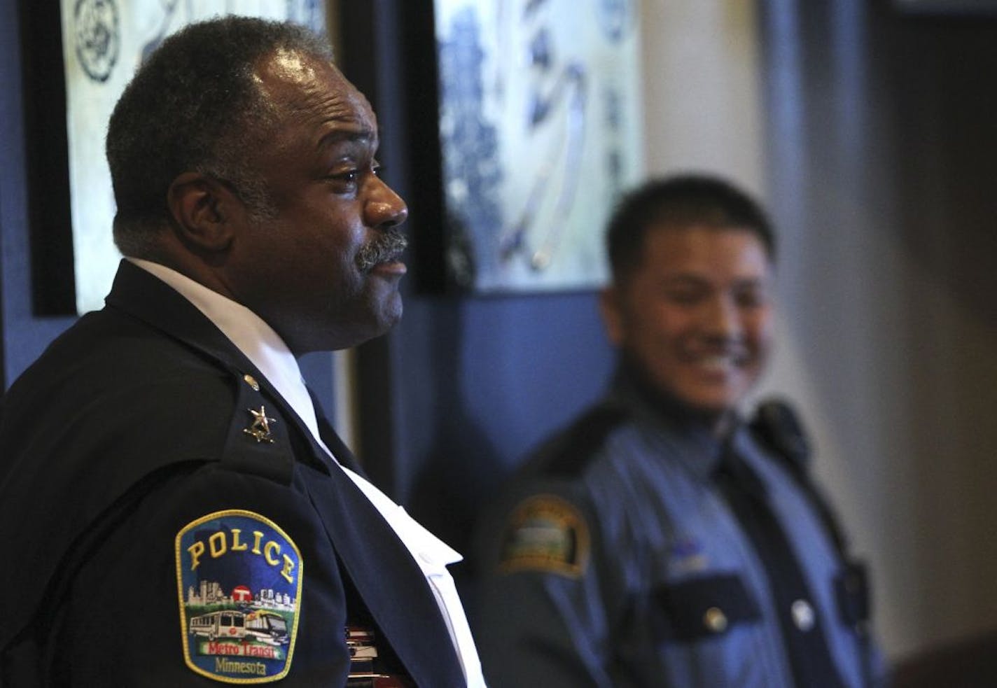 John Harrington was honored for his work with the Asian community. St. Paul officer Jimmy Yang, background, was inspired by him two decades ago.