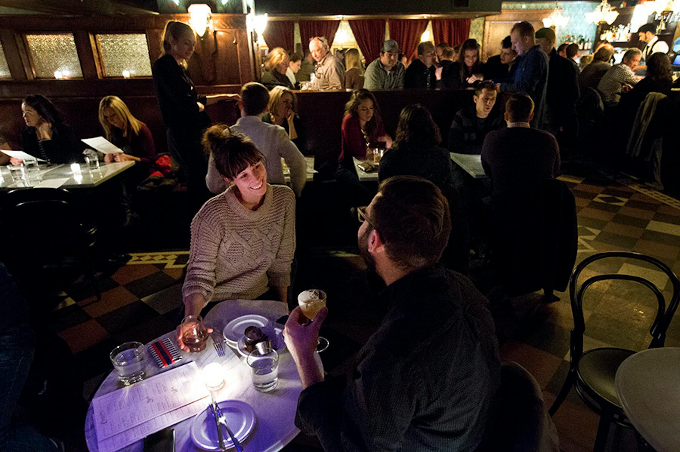 Whitney Shook, 29 and Andrew Yarish, 27 both of Minneapolis sat and spoke at a small table at Volstead's Emporium in Uptown.