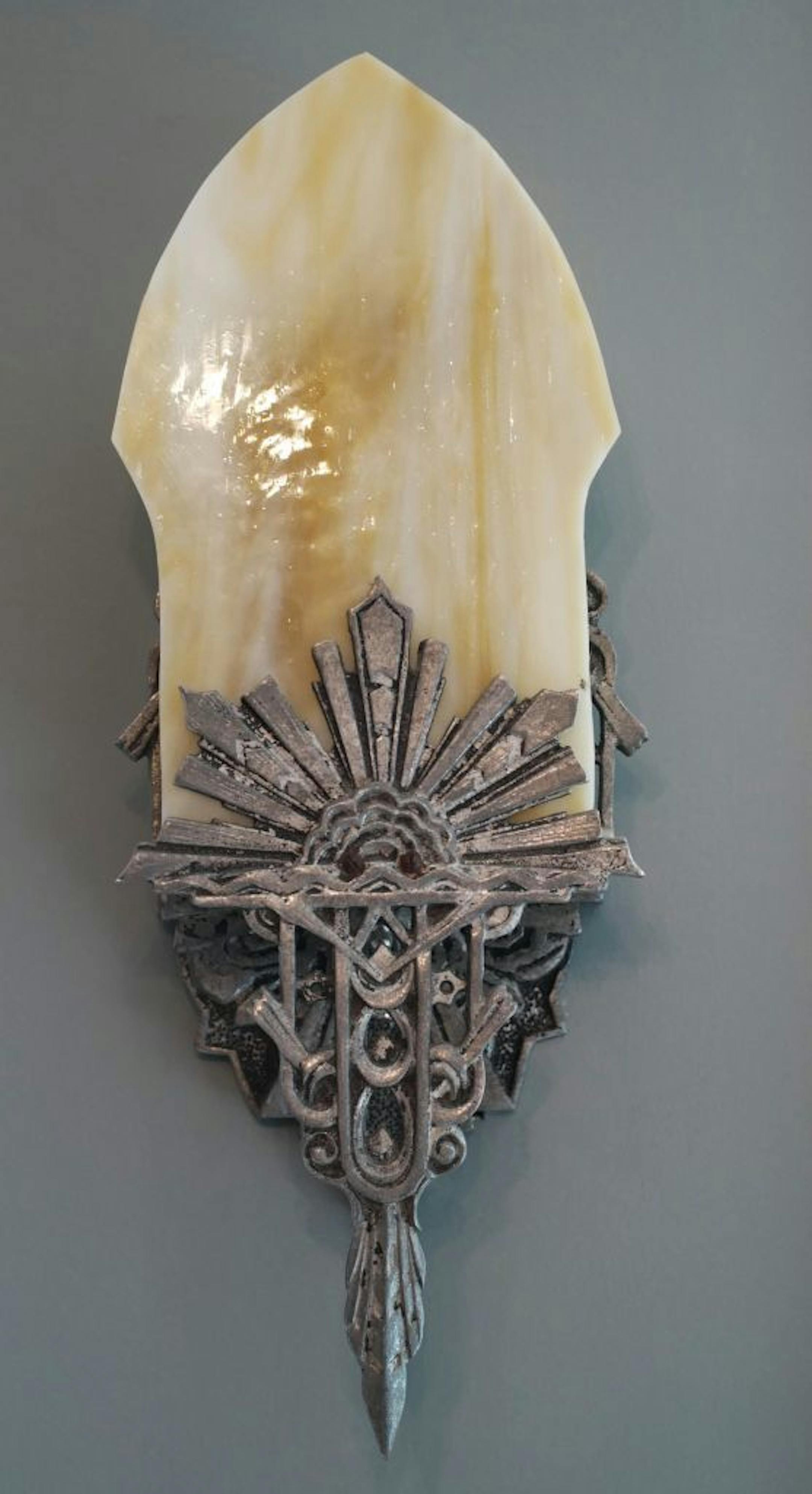 Art Deco inspired wall sconces add period character to the refinished attic of the 1901 home in Minneapolis.