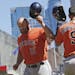 RETRANSMISSION TO CORRECT PITCHERS NAME - Houston Astros' Evan Gattis, left, and Marwin Gonzalez tip helmets after Gattis's solo home run off Minnesot