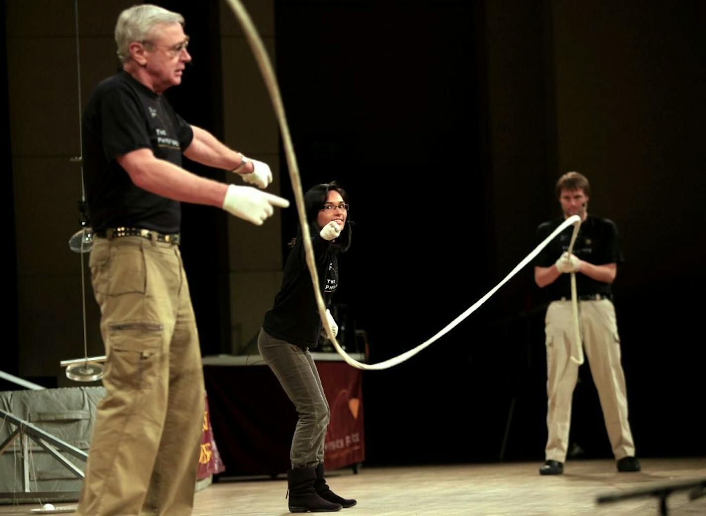 L to R: Retired teacher Jack Netland, Physical science teacher at North Jr. High, and Physics teacher at Hopkins, Maritza Roberto and Maple Grove HS science teacher Fred Orsted perform a experiment on waves at "Physics Circus" in the Minneapolis Convention Center in Minneapolis, MN on January 10, 2013.