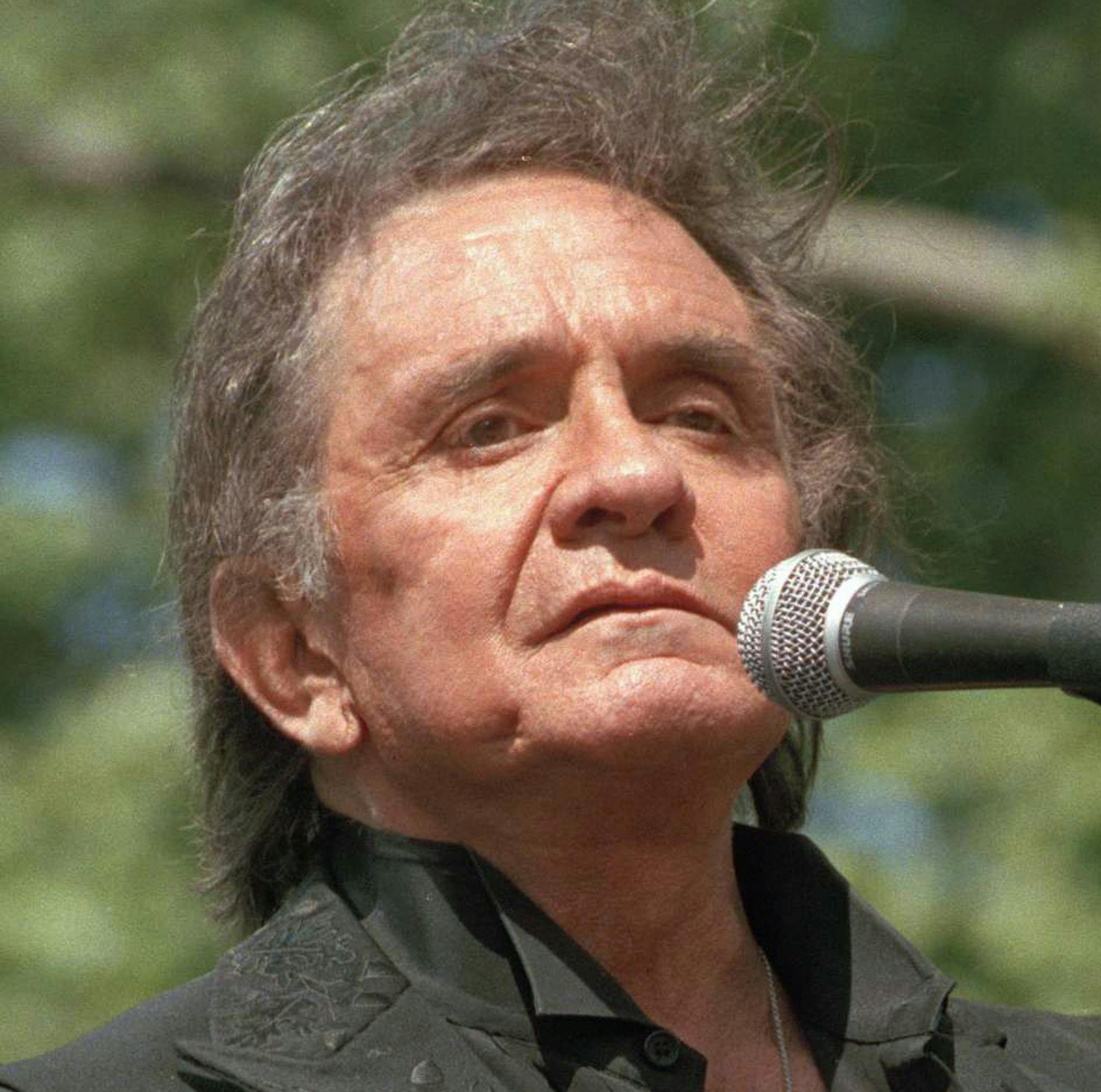 FILE - In this May 23, 1993 file photo, country legend Johnny Cash performs at a benefit concert at Central Park in New York. Cash's first gold record for the recording of ìI Walk the Line" is now available for viewing at the Johnny Cash Museum in Nashville, Tenn. Bill Miller, the founder of the museum, purchased it from a private collector in Germany earlier this year. (AP Photo/Joe Tabacca, File)