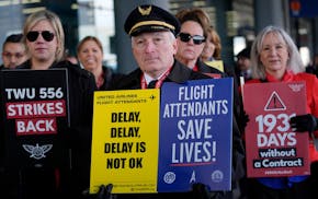 Flight attendants and a pilot protest at O'Hare International Airport in Chicago, Tuesday, Feb. 13, 2024. Three separate unions representing flight at