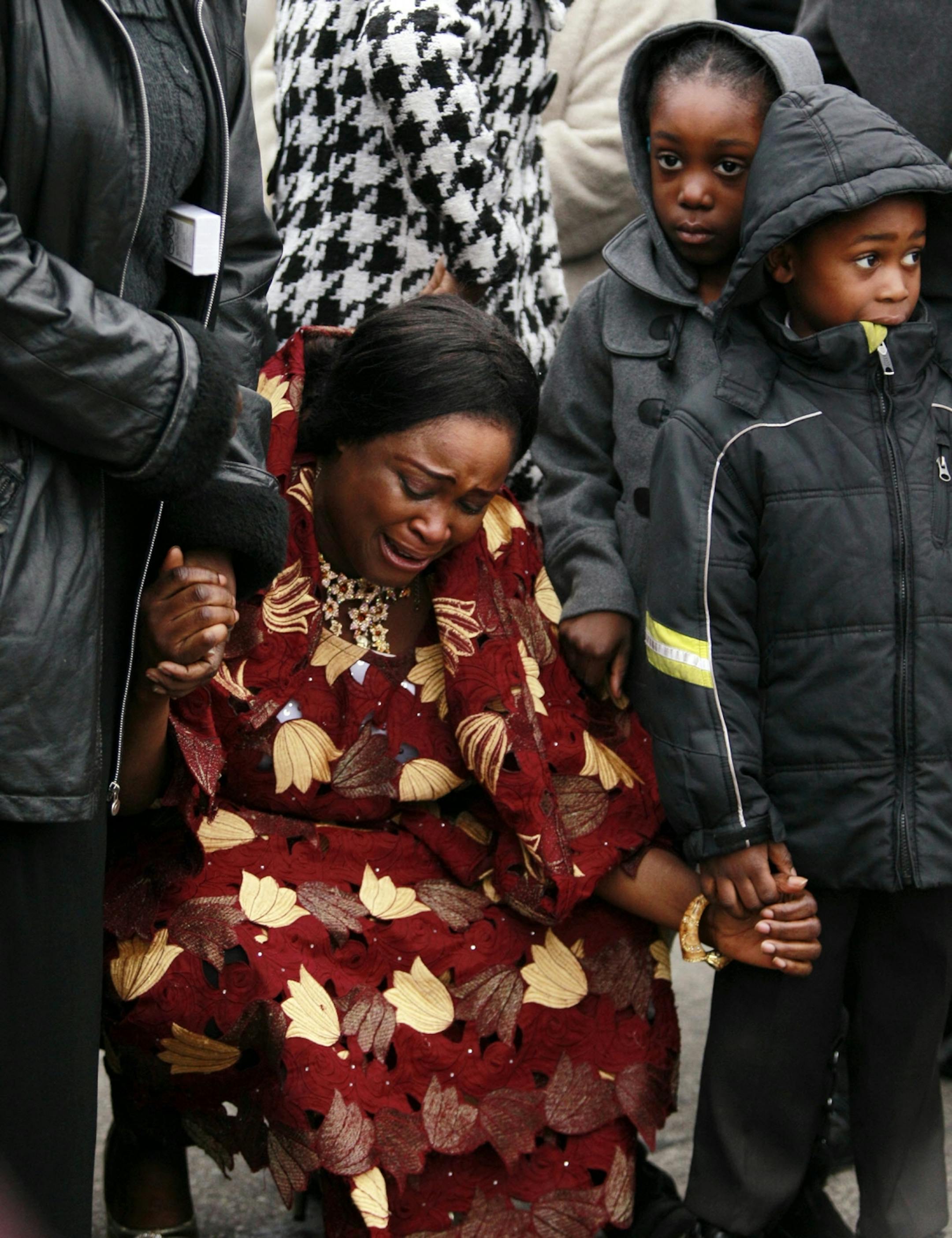 Cecelia Seward, a family friend, grieves during a vigil for murder victims Beatrice Wilson and her grandson Peter Wilson outside the house where the crime took place, in Minneapolis, Sunday, Nov. 4, 2012. Both victims were allegedly killed by Ishmael Roberts, Beatrice Wilson's son, with a Samurai sword. (Genevieve Ross/Special to the Star Tribune) ORG XMIT: 6VIGIL1105