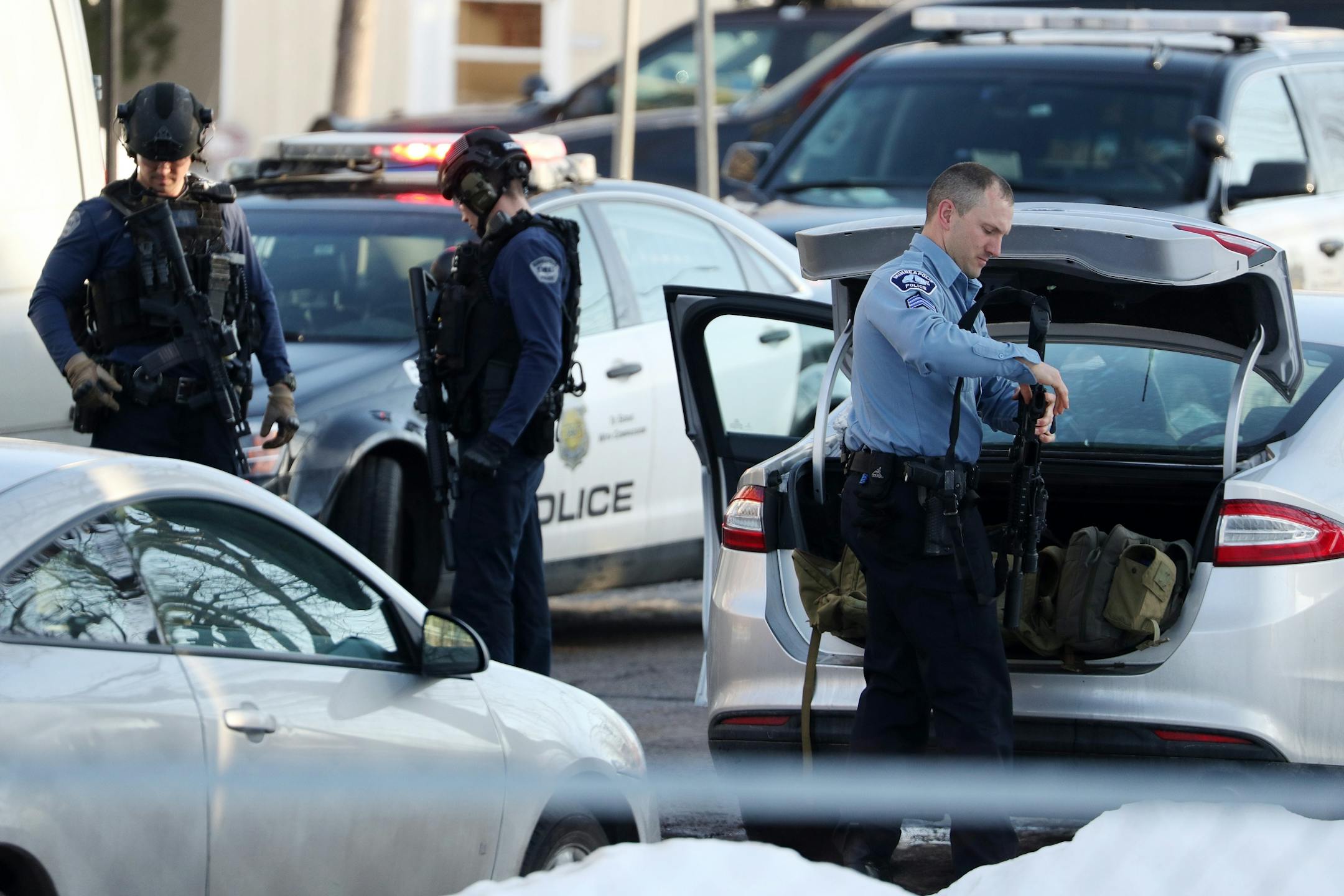 Police readied their tactical gear before entering Patrick Henry High School after a gunman was reported getting off a Metro Transit bus near the school Tuesday.