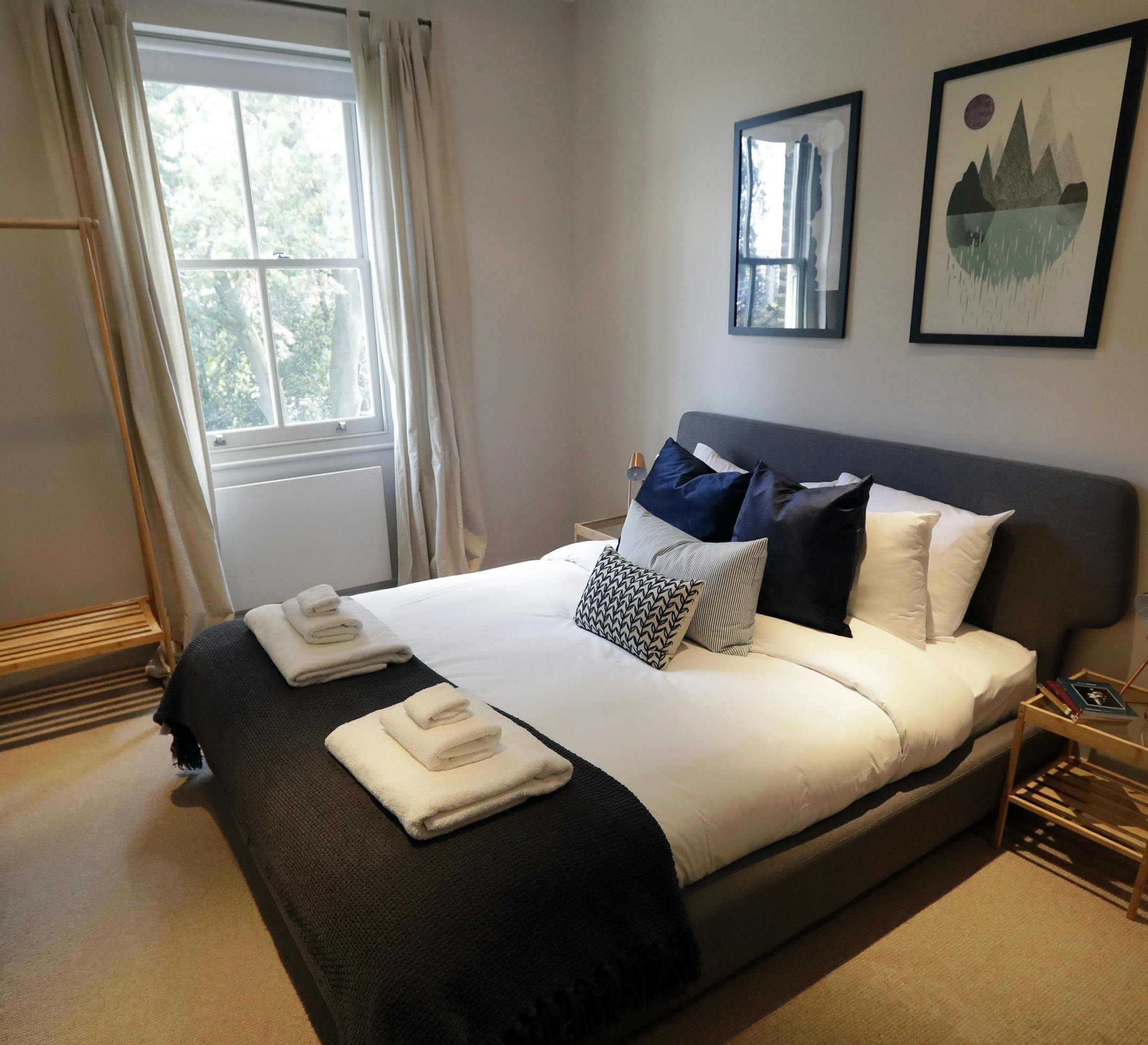 FILE - This Sept. 28, 2018, file photo shows the bedroom of a flat that will be available for short term rent in London. Marriott is pushing more heavily into home-sharing, confident that its combination of luxury properties and loyalty points can lure travelers away from rivals like Airbnb. Marriott has been testing in London in partnership with a home-sharing company called Hostmaker. (AP Photo/Kirsty Wigglesworth, File)