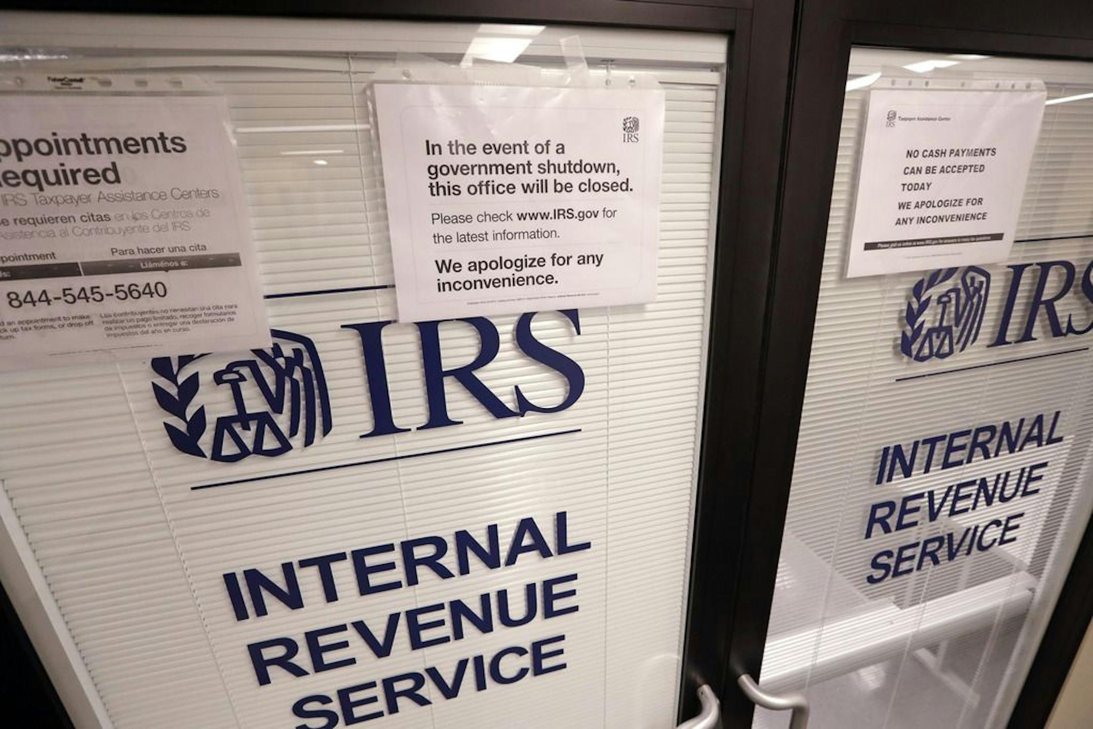 Doors at the Internal Revenue Service (IRS) in the Henry M. Jackson Federal Building are locked and covered with blinds as a sign posted advises that the office will be closed during the partial government shutdown Wednesday, Jan. 16, 2019, in Seattle. The shutdown is in its fourth week with no end in sight.