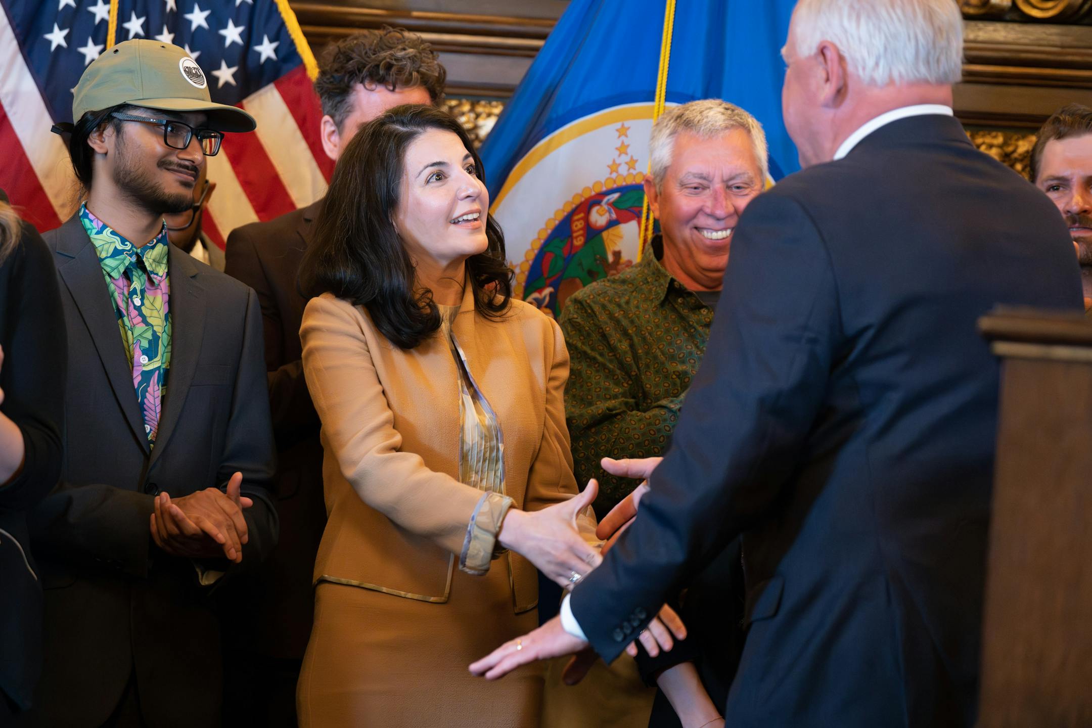 Leili Fatehi, campaign manager for MN is Ready, shook hands with Gov. Tim Walz after the bill signing Tuesday, May 30, 2023 St. Paul, Minn. Former Governor Jesse Ventura was on hand as Gov. Tim Walz legalized marijuana in Minnesota with the stroke of a pen on Tuesday. ] GLEN STUBBE • glen.stubbe@startribune.com