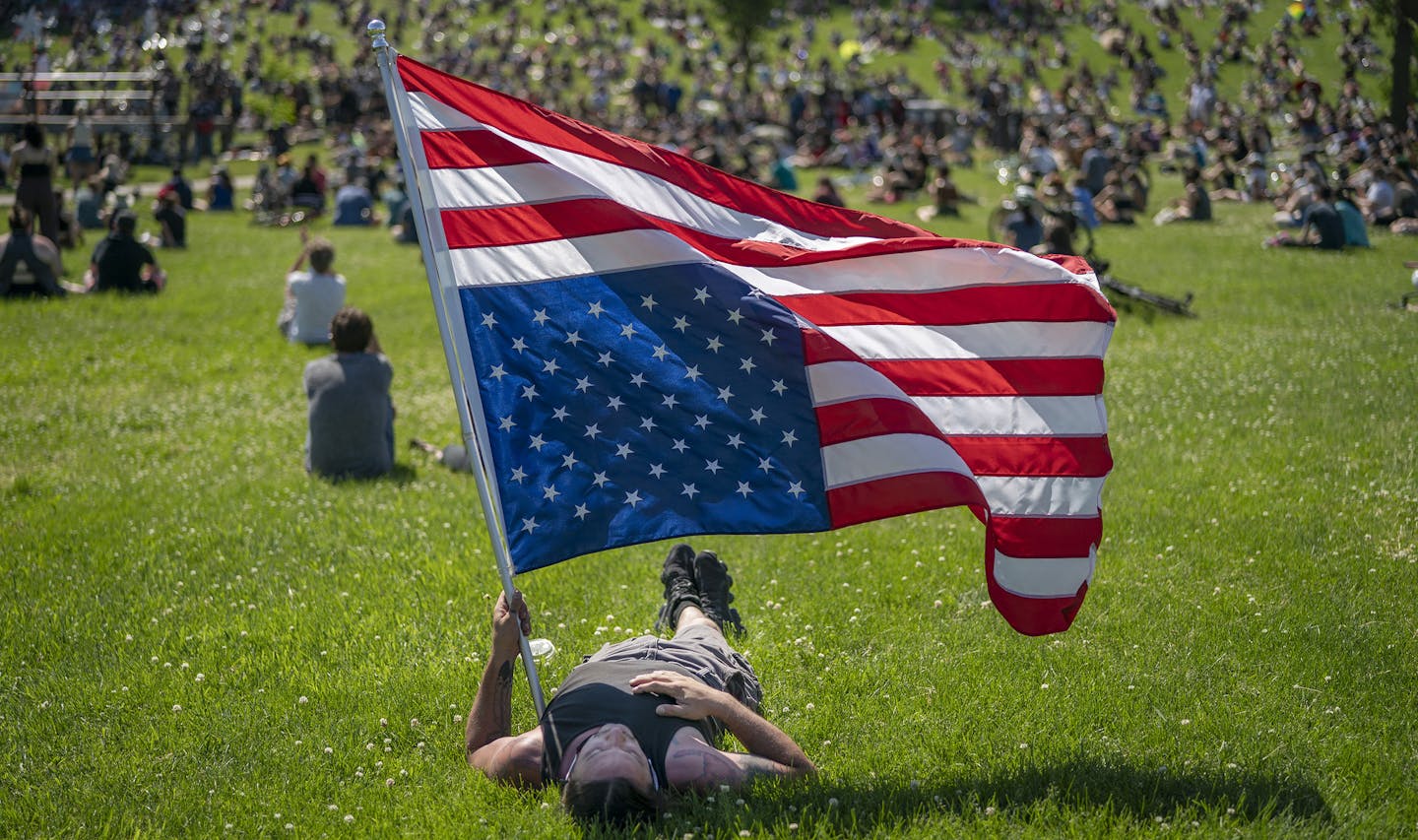 Rory Wakemup holds an American flag at the "The Path Forward" meeting at Powderhorn Park, a meeting between the Minneapolis City Council and community members on Sunday, June 7, 2020 in Minneapolis, Minn. (Jerry Holt/Minneapolis Star Tribune/TNS) ORG XMIT: 1683930