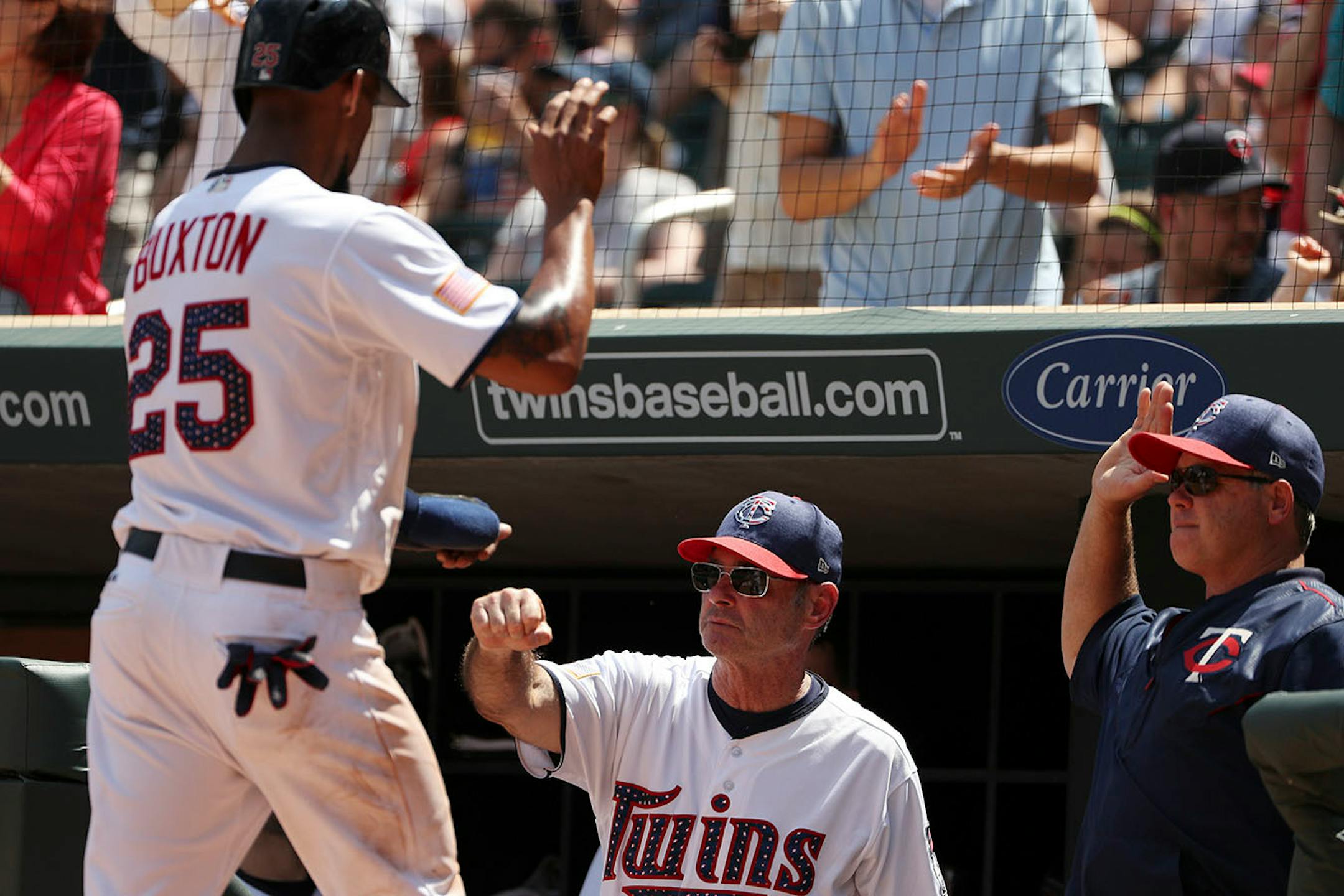 Minnesota Twins center fielder Byron Buxton (25) celebrated with Minnesota Twins manager Paul Molitor (4) after scoring in the fifth inning.