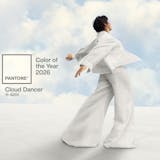 Woman in white on white background with sky background inset with clouds.