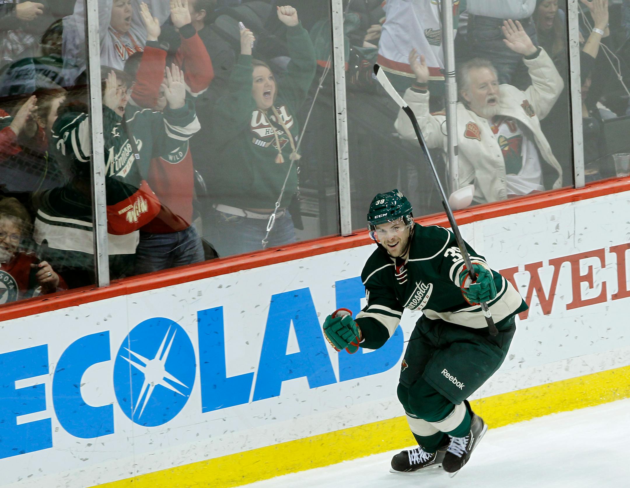 Minnesota Wild defenseman Nate Prosser celebrates after scoring the winning goal on Dallas Stars goalie Kari Lehtonen during overtime of an NHL hockey game in St. Paul, Minn., Saturday, Jan. 18, 2014. The Wild won 3-2 in overtime. (AP Photo/Ann Heisenfelt)