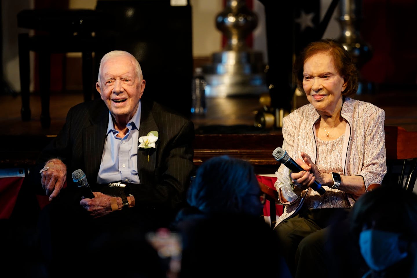 Former President Jimmy Carter and his wife former First Lady Rosalynn Carter sit together during a reception to celebrate their 75th anniversary Satur