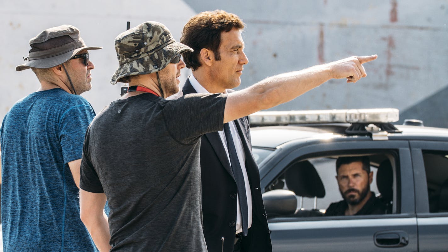 Actor Clive Owen, right, and director Neill Blomkamp, center, on the set of BMW Films&#x2019; &#x201c;The Escape.&#x201d;