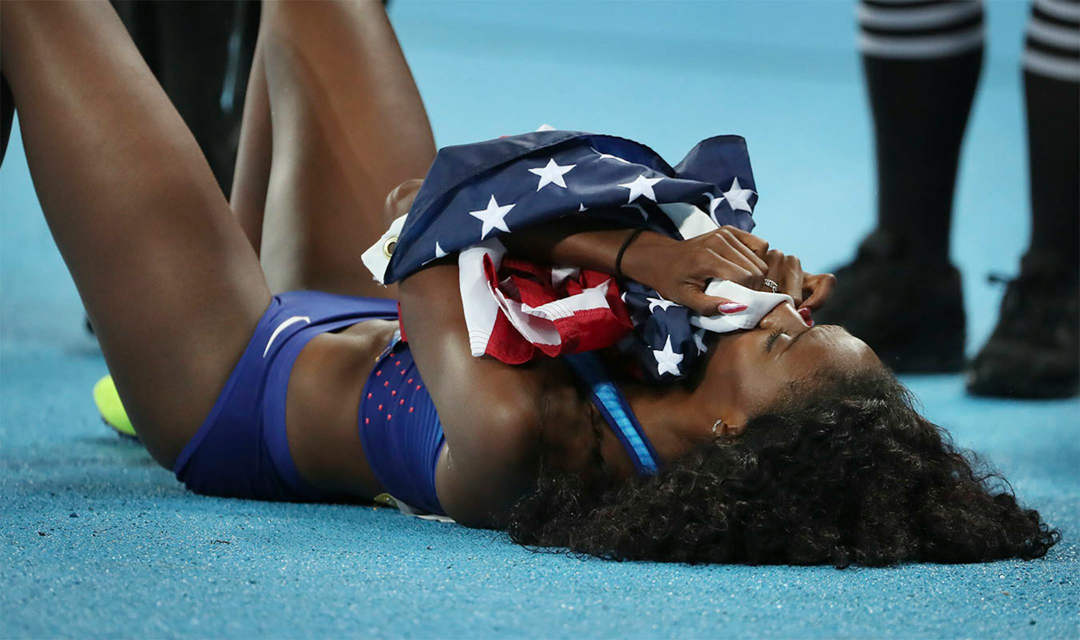 Women's 400 meter hurdles. USA's Ashley Spencer was overcome with emotion as she lay on the track smelling the American flag after winning the silver medal. Her teammate Dalilah Muhammad won gold.